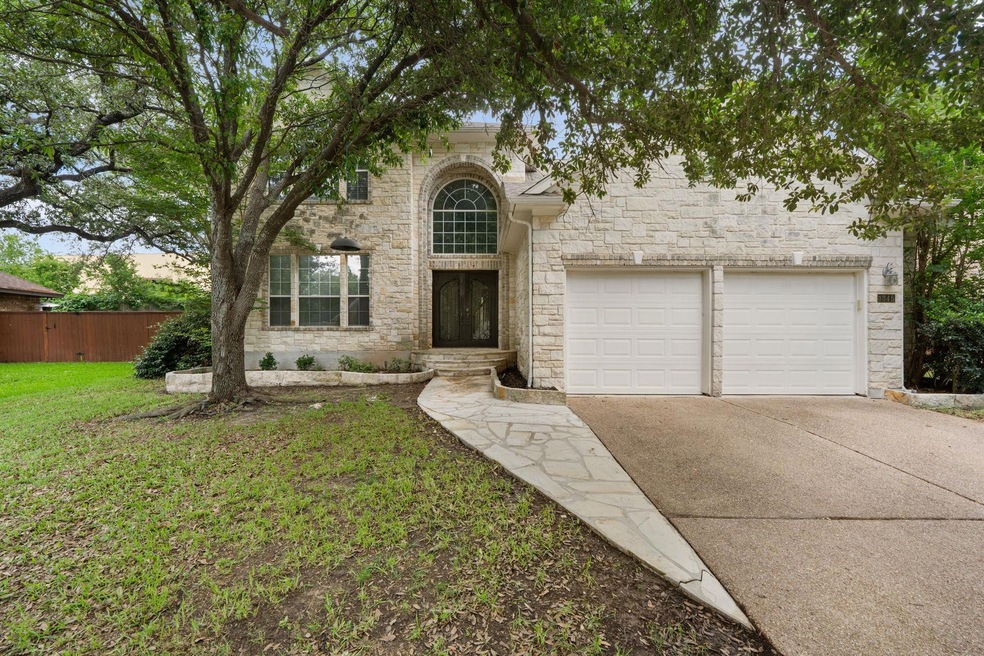 Traditional-style home with stone siding, drivewa