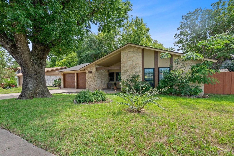 Mid-century modern home featuring stone siding, d
