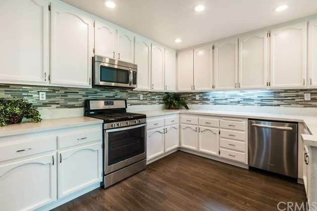 Gorgeous glass backsplash adds sophistication.