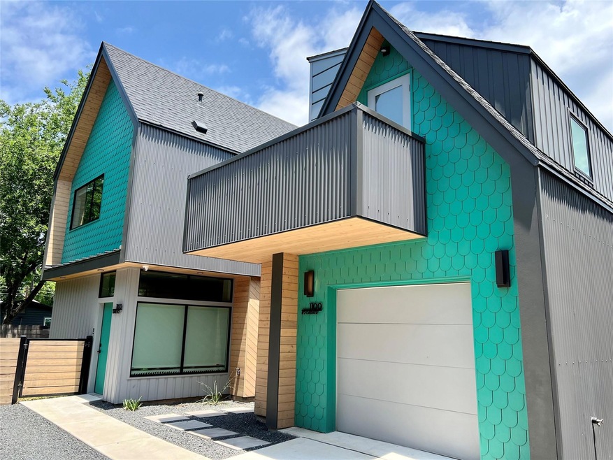 View of front of house with a balcony, fence, and