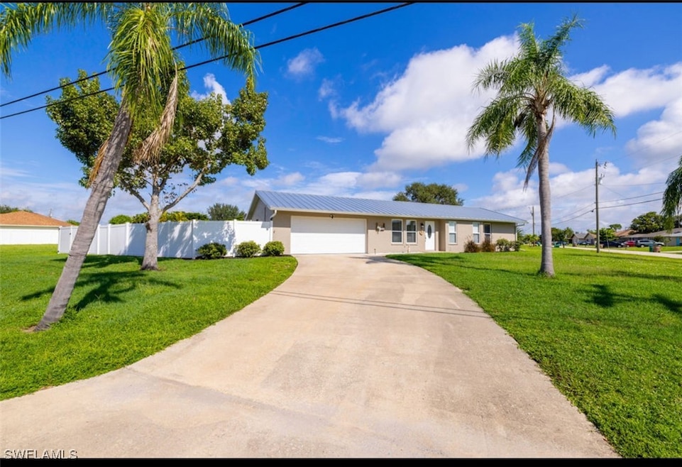 Single story home featuring a front lawn and a gar