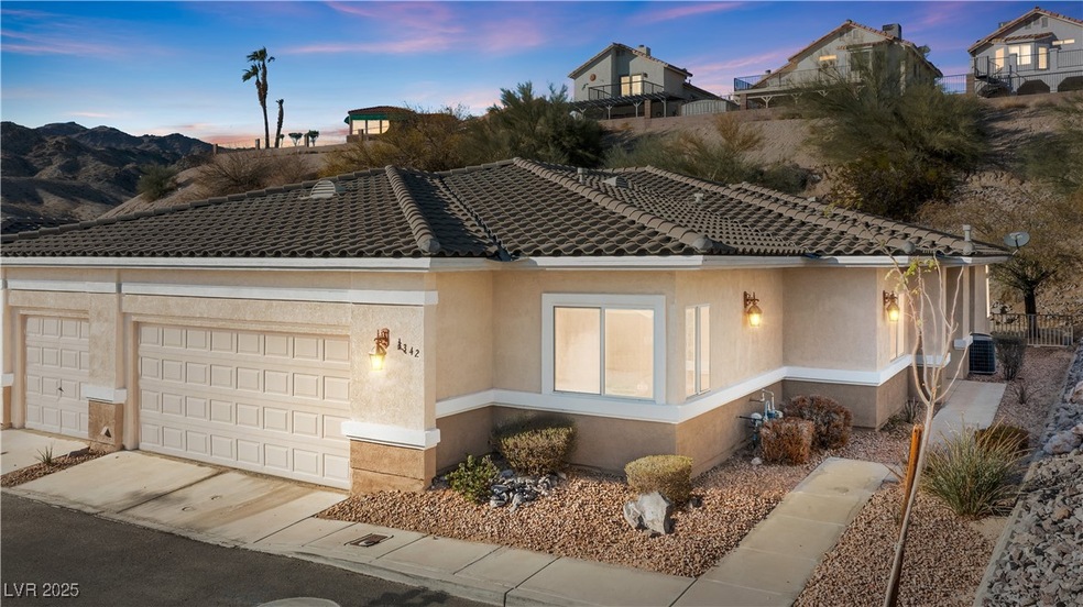 View of front of home featuring driveway, a tile r