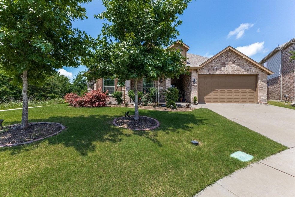 View of front of house with a garage and a front yard