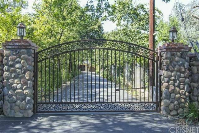 Beautiful front gate on tree lined street