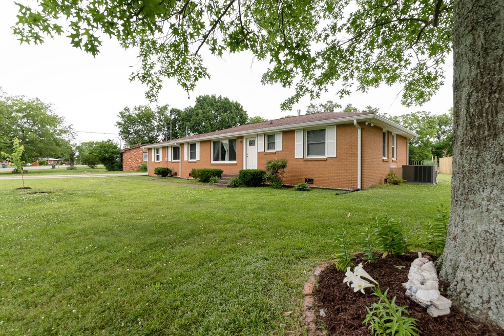 Welcome home! Ample green space and lovely established shade trees. 