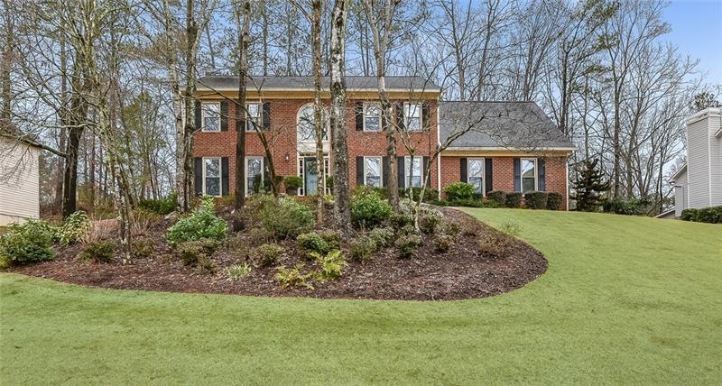 Professionally landscaped yard with landscape ligh