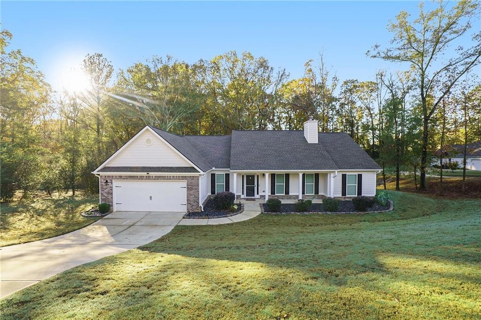View of front of house with a front yard, a garage
