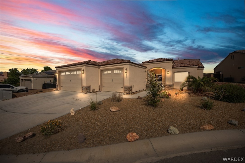 Mediterranean / spanish-style home with garage