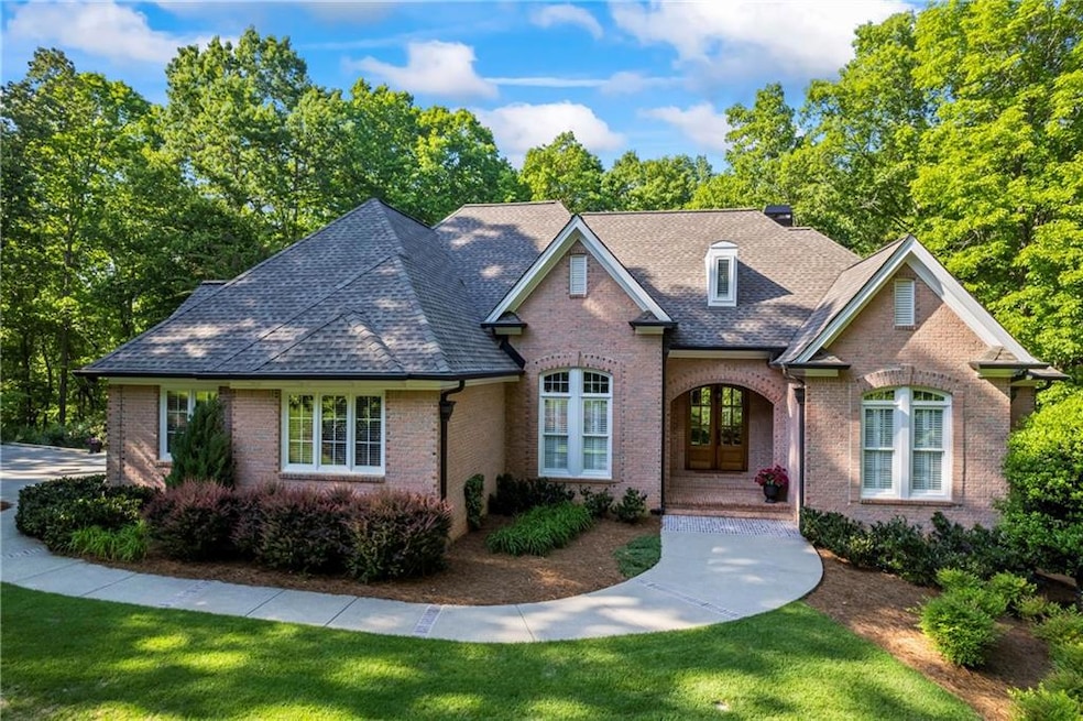 Single story home with brick siding, roof with shi