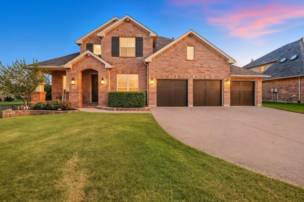 View of front of property with a front yard, driveway, brick siding, and roof with shingles