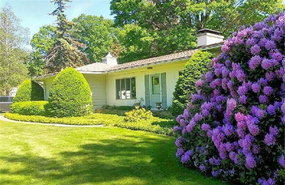 Front exterior with fabulous manicured grounds....