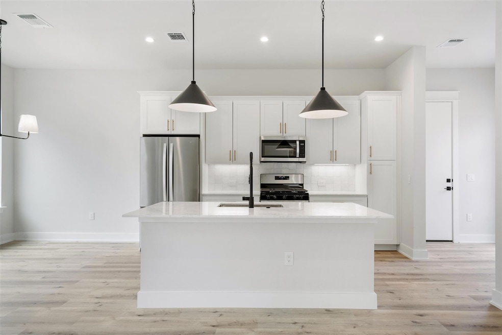Kitchen featuring appliances with stainless steel