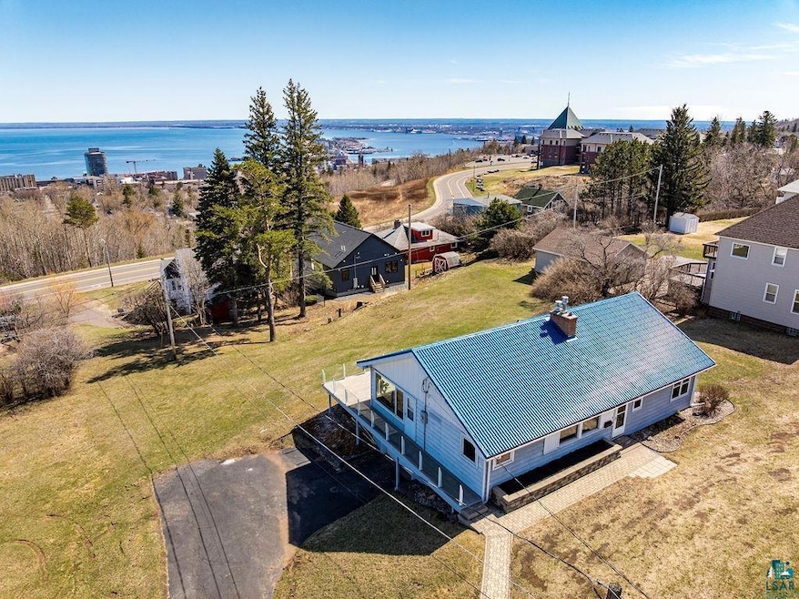 Birds eye view of property with a water view