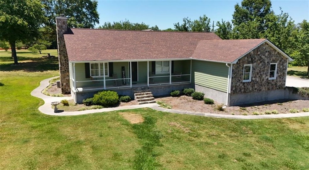 Ranch-style home featuring covered porch and a fro