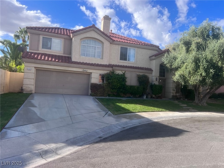 Mediterranean / spanish-style home featuring a garage, stucco siding, driveway, a tile roof, and a chimney