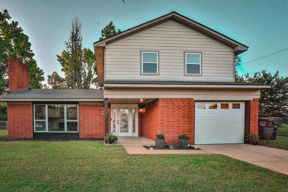 Front of property with a front lawn and a garage