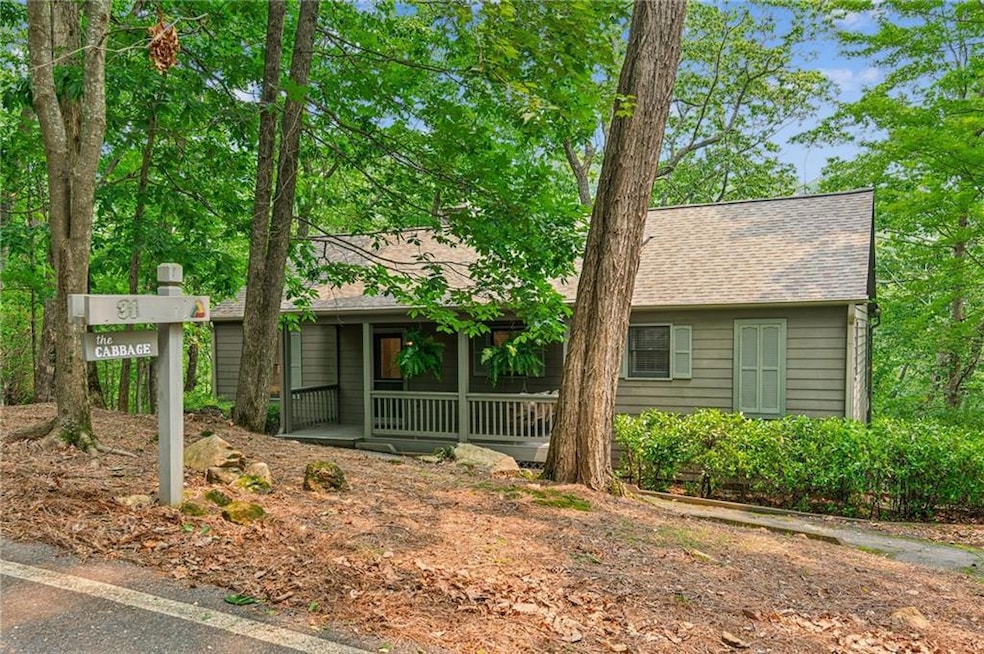 Ranch-style house with covered porch and a shingled roof
