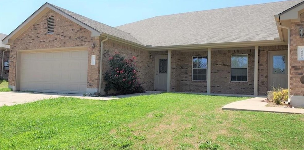 Single story home with brick siding, an attached 