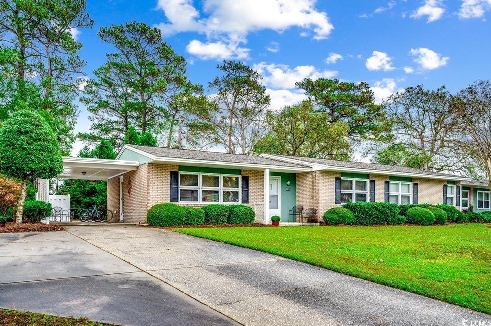 Ranch-style home with a front yard and a carport
