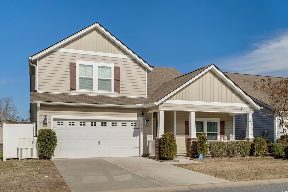 Craftsman inspired home featuring a garage and cov