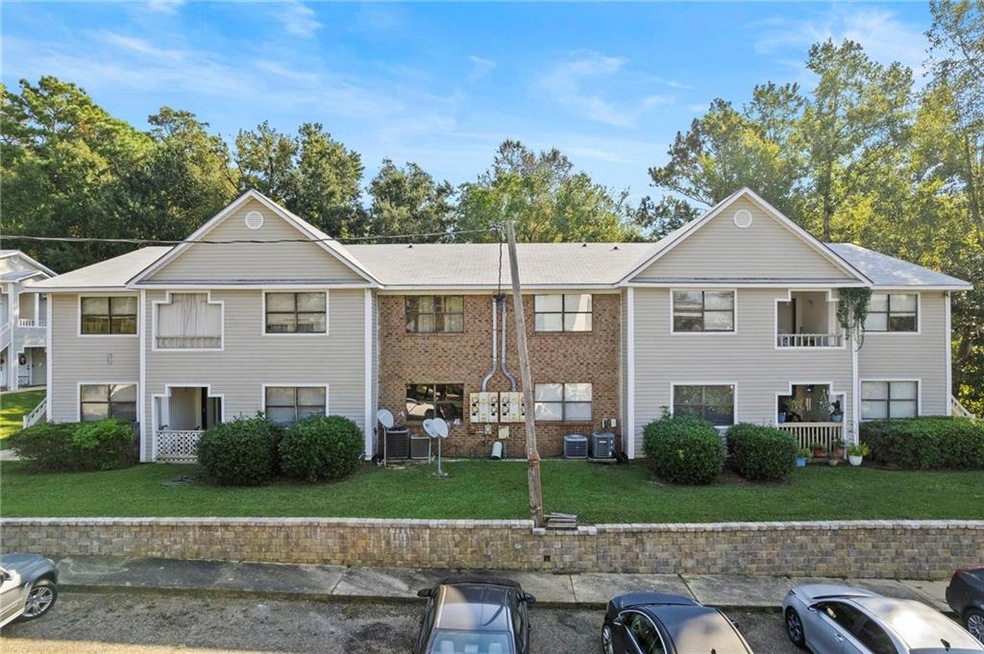 View of front facade with a front yard and a balco