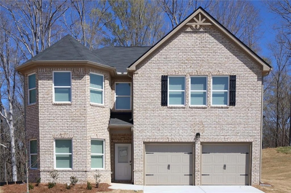 View of front facade with brick siding and drivewa
