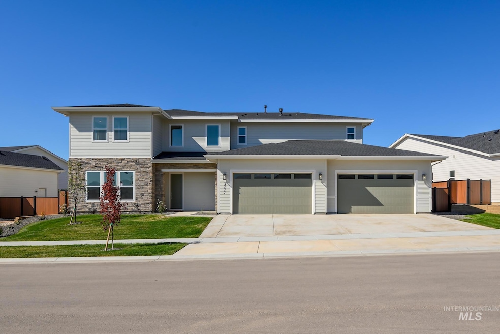 Prairie-style house with concrete driveway, a garage, and stone siding