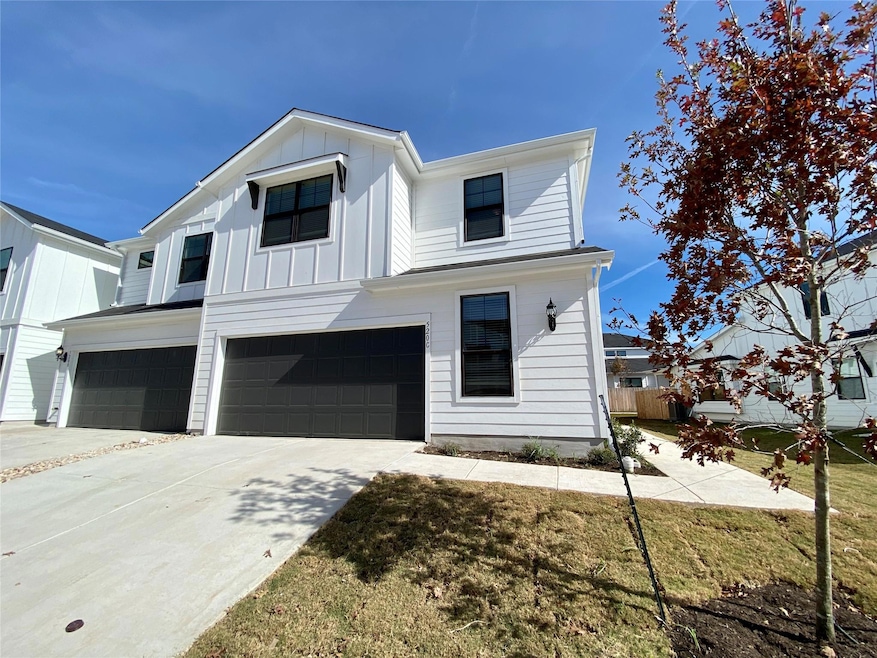 View of front of home featuring a garage, board a