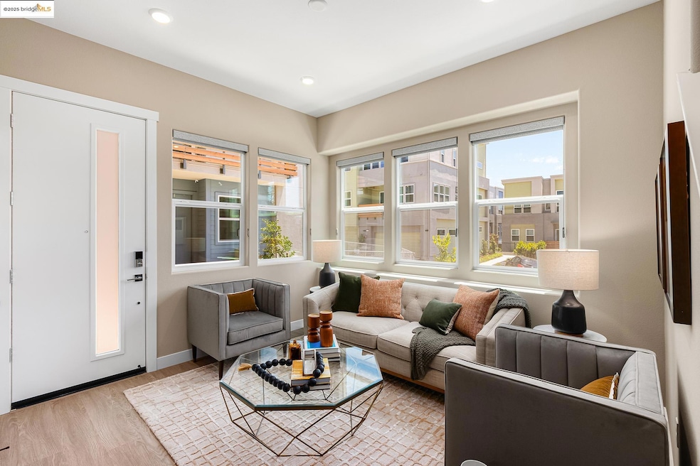 Living area with plenty of natural light, wood finished floors, and recessed lighting