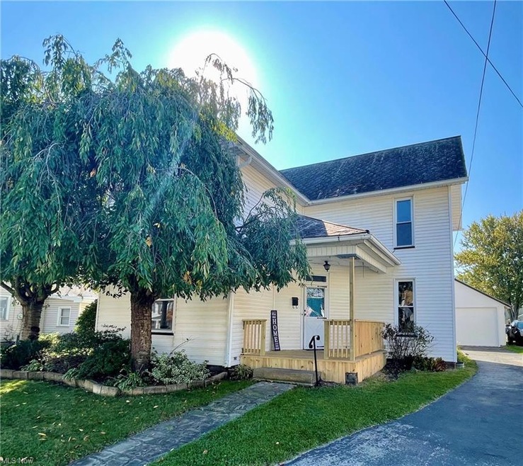 View of front of house with a porch, a front lawn,