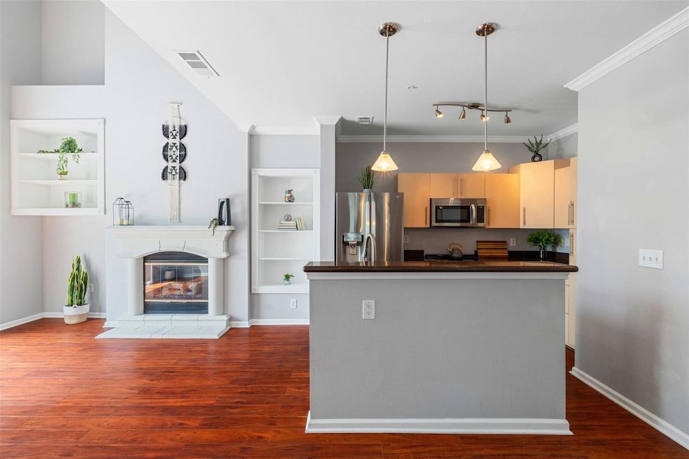 Kitchen with stainless steel appliances, dark cou