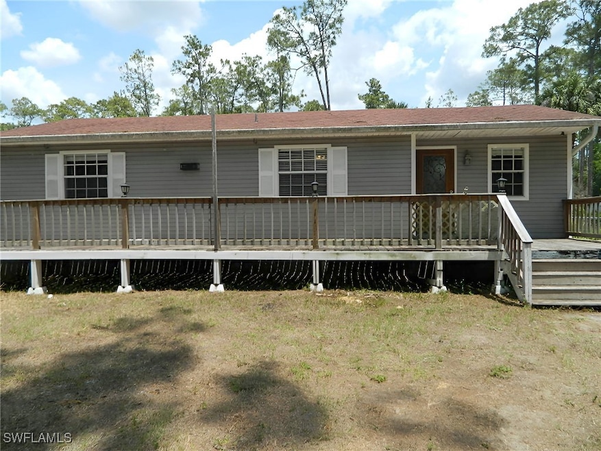 Back of house with a deck