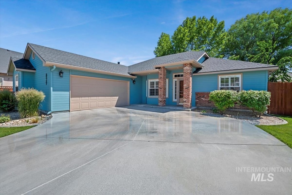Single story home with a garage, driveway, and roof with shingles