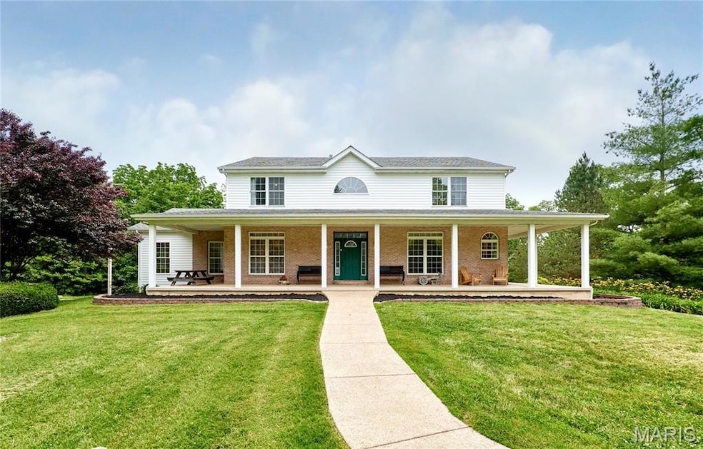 View of front of house with covered porch and front yard