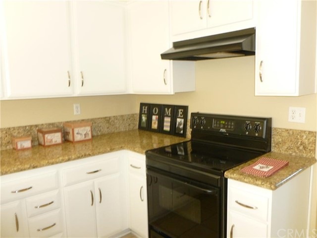 Updated white kitchen has granite counters
