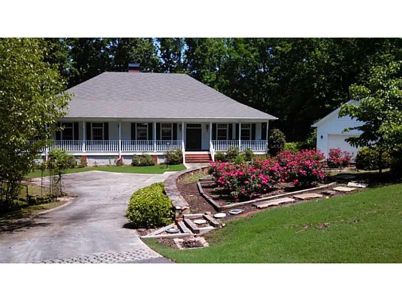 Exterior Front. almost 2 acres of lush gardens.  Y