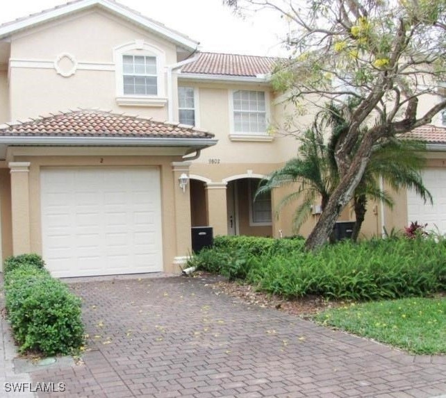 View of front of home featuring stucco siding, dri