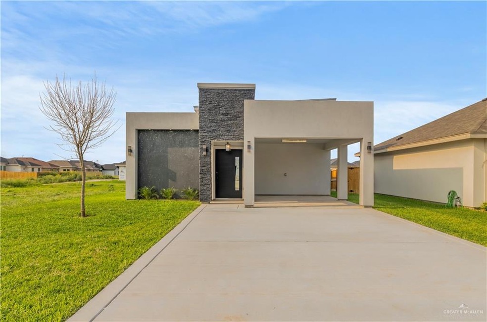 View of front of house featuring a front lawn and a carport