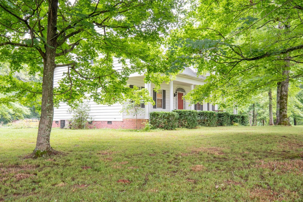 Standing in front yard left of the home.