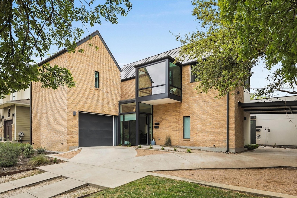 Contemporary home featuring a standing seam roof,