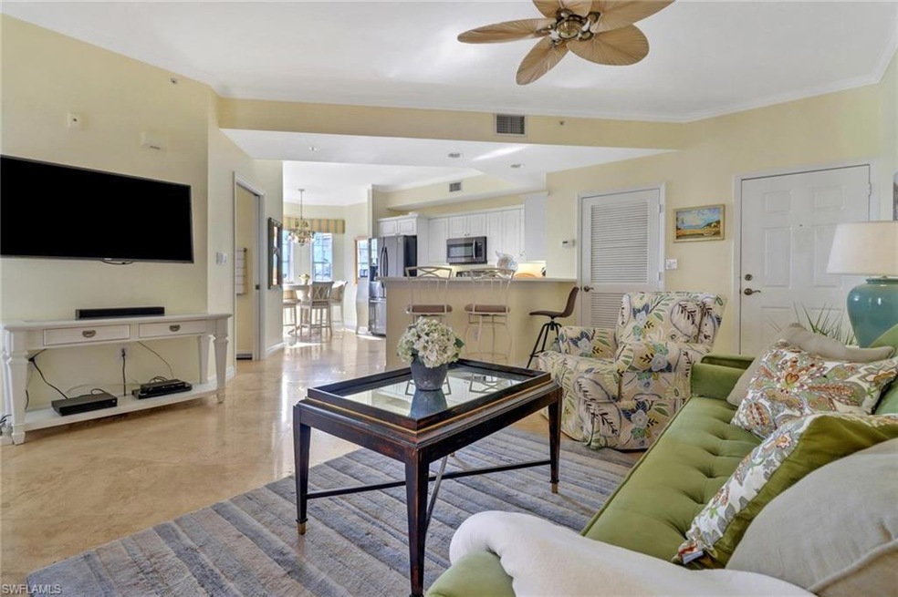 Living room featuring ceiling fan with notable cha