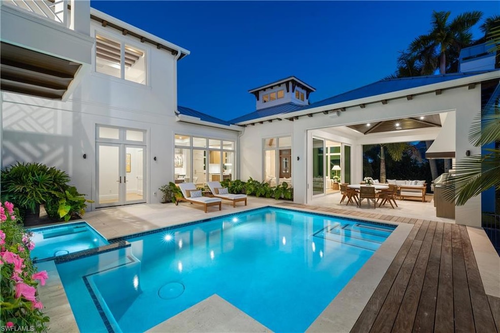 Beautiful pool with water feature and hot tub.
