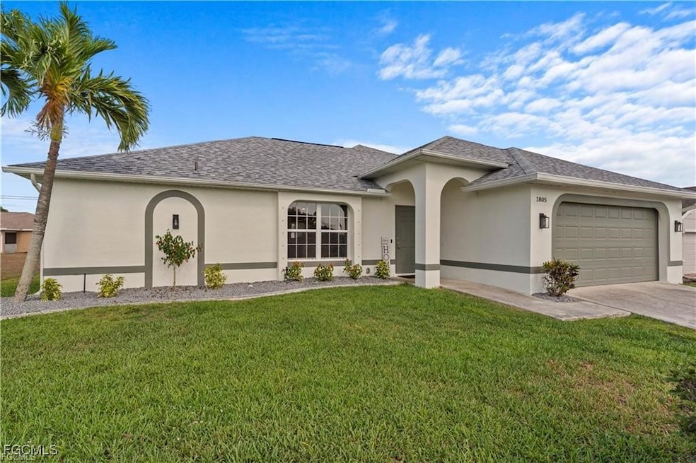 Single story home featuring stucco siding, an attached garage, concrete driveway, a front yard, and roof with shingles