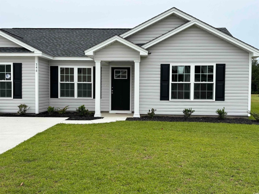 View of front facade with a shingled roof and a front lawn