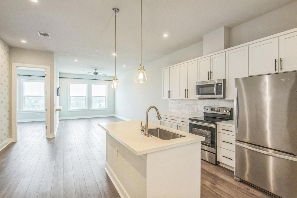 Kitchen with stainless steel appliances, a sink, 