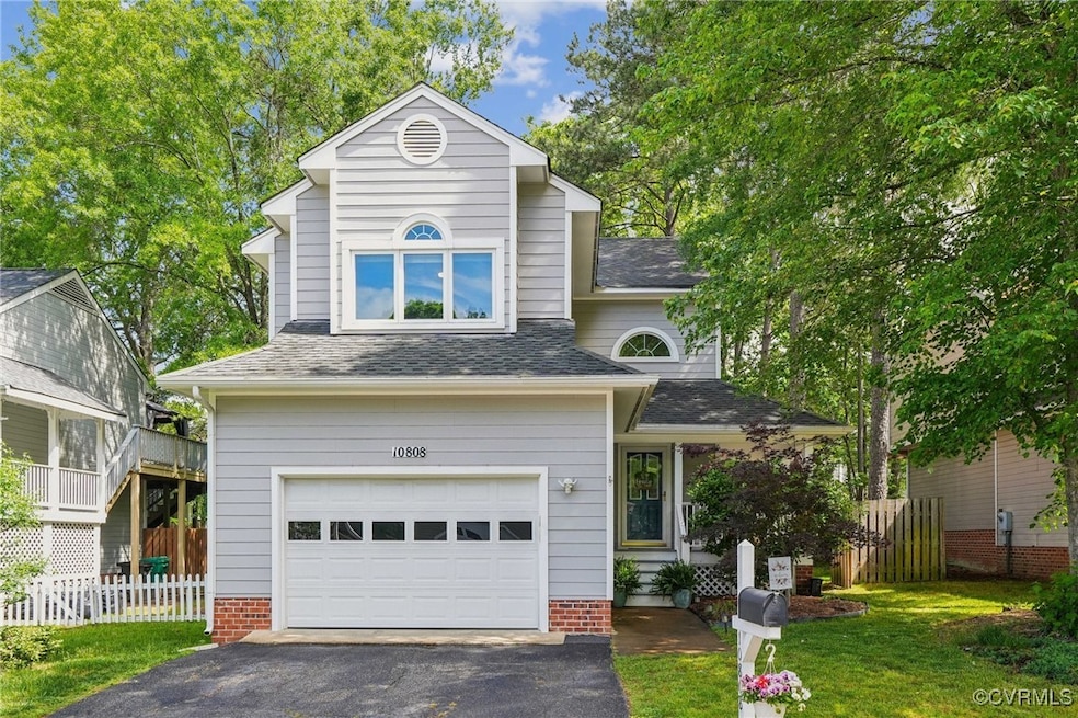 Traditional-style house with driveway, an attached