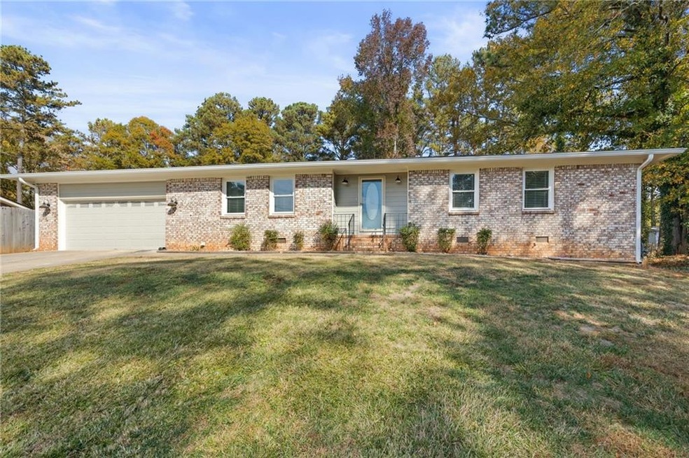 Single story home featuring a garage and a front l