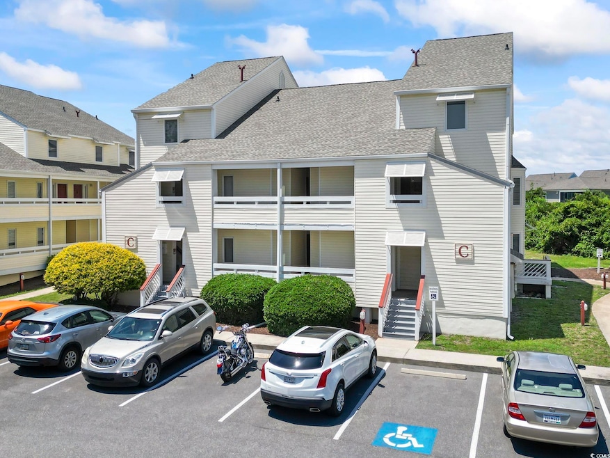 View of property with entry steps and uncovered parking