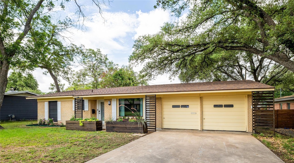 Ranch-style house featuring a garage, brick sidin