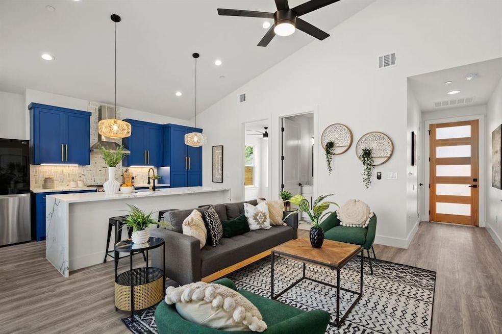 Living area featuring ceiling fan, light wood-typ